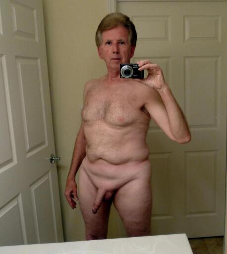 Andrew self photo standing nude in the bathroom.