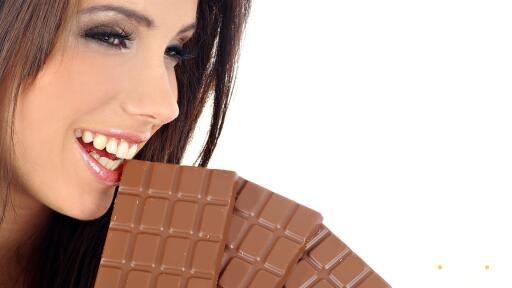 Beautiful girl eating chocolate
