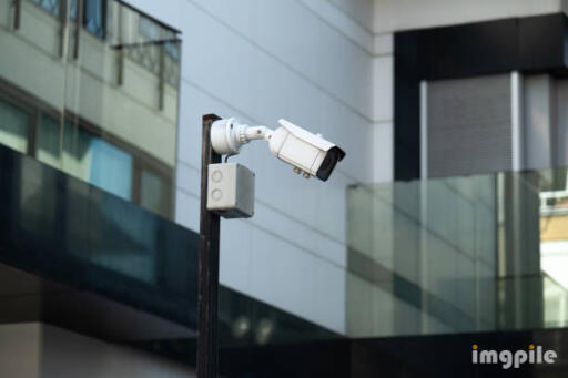 The surveillance camera continuously shoots and video surveillance on a city street. Modern monitori