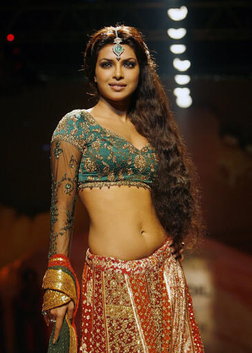Bollywood actress Priyanka Chopra displays a creation by designer Ritu Kumar on the opening show of 