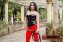 livecamdominatrix black haired Latina Domme with black whip in red PVC pants