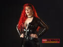 black vinyl top mistress with red hair on livecamfemdom