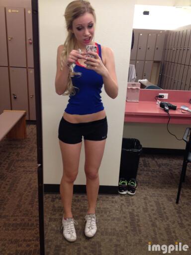 Sweet girl taking selfie in jogging gear blue outfit