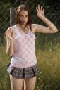 Sweet girl posing net barrier fence Fame Girl Isabella