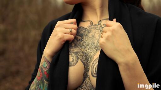 Womans tattoo of octopus on chest